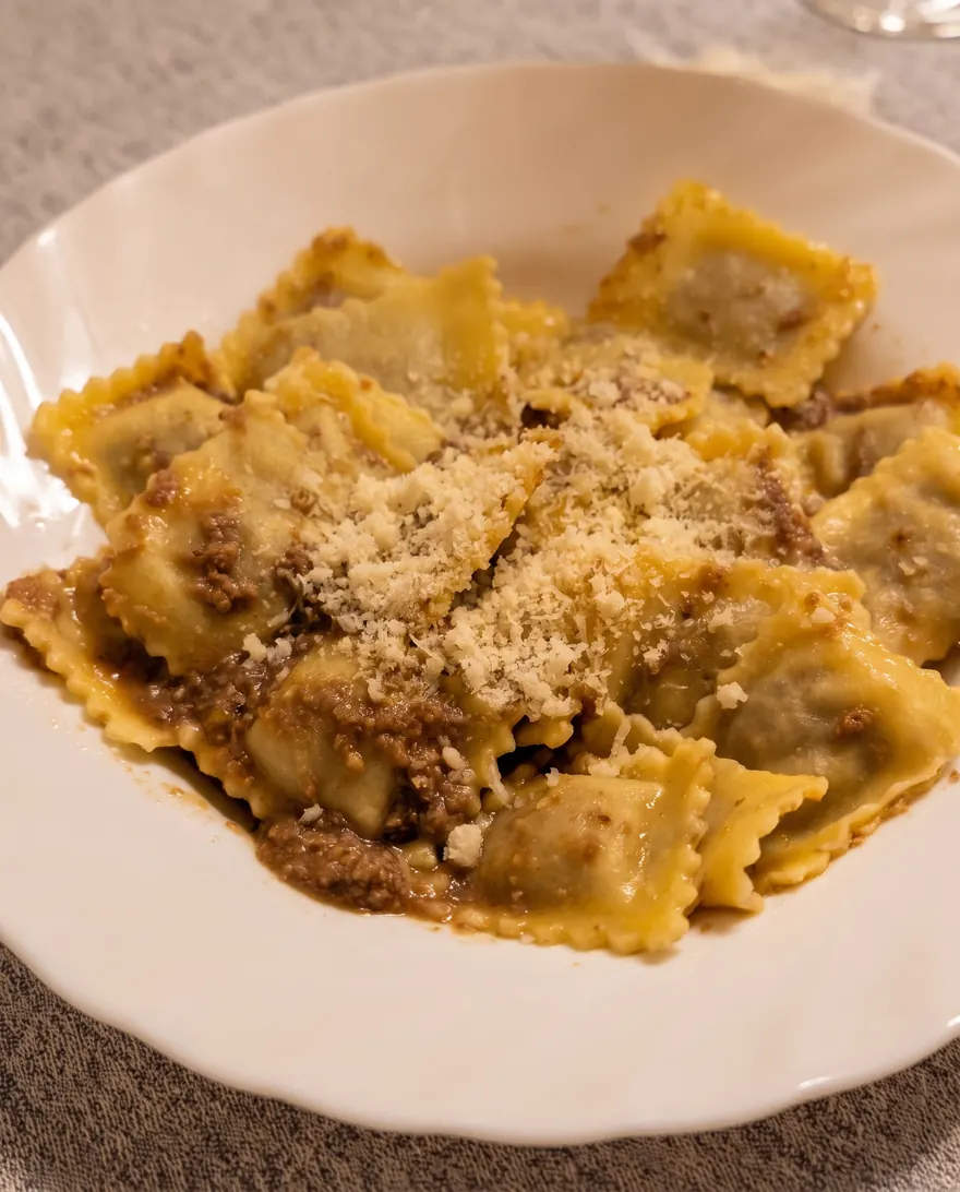 Agnolotti allo stufato con parmigiano grattugiato.